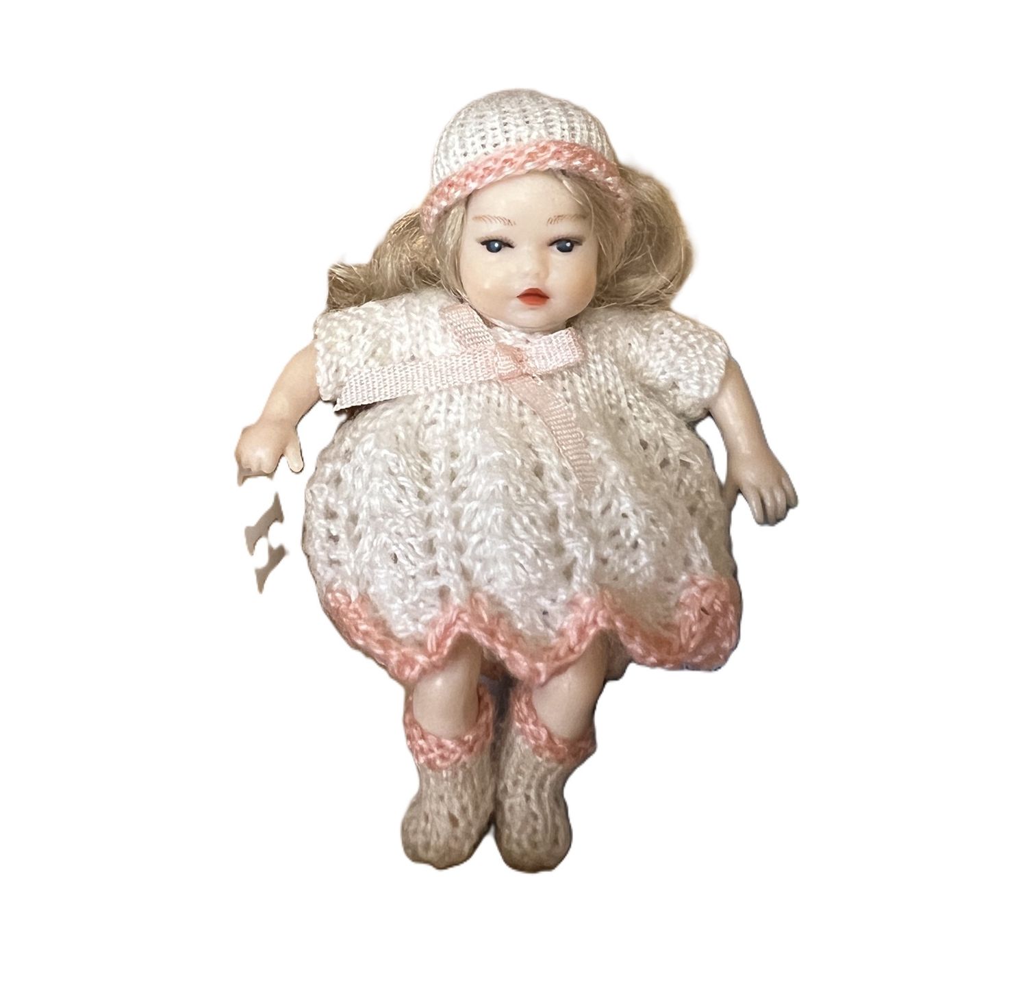 Heidi Ott Baby in white dress with hat and pink trim