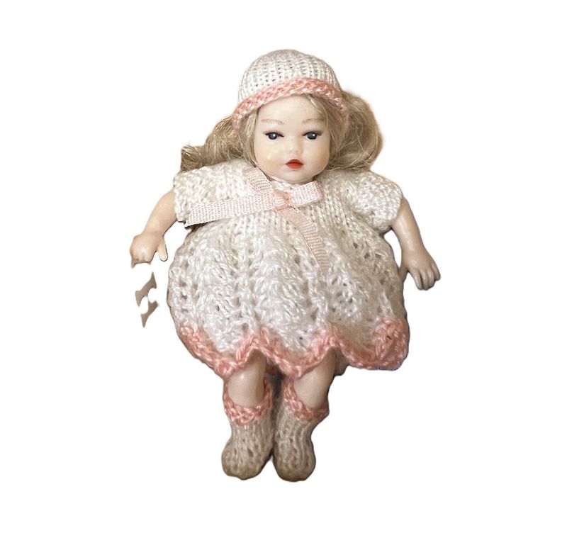 Heidi Ott Baby in white dress with hat and pink trim