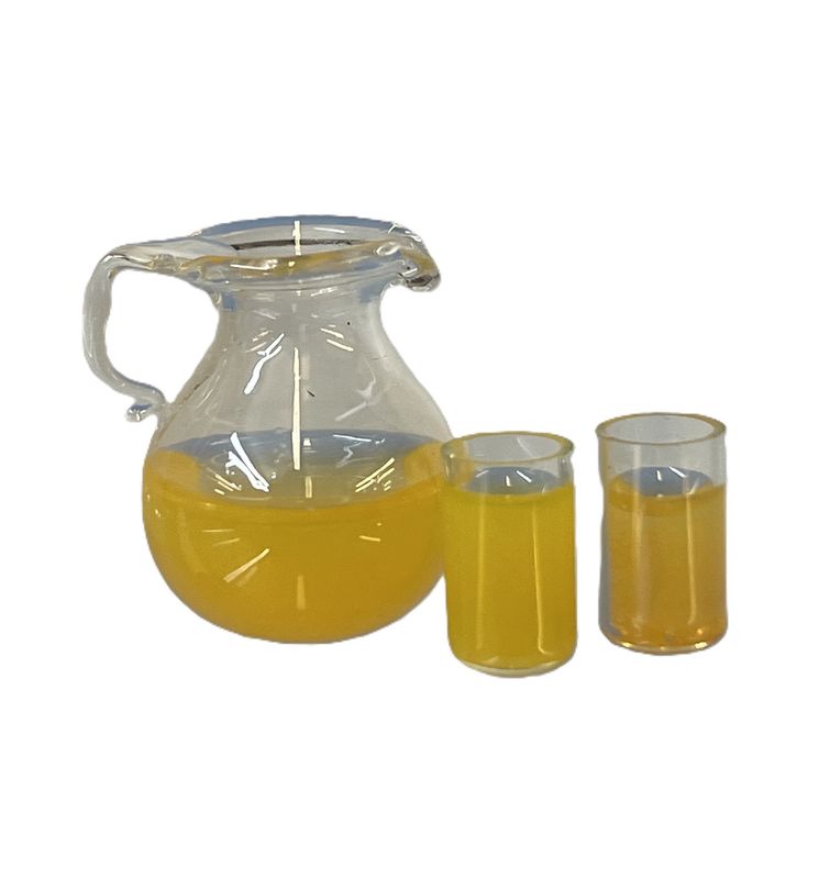 Orange juice in glass pitcher and two glasses