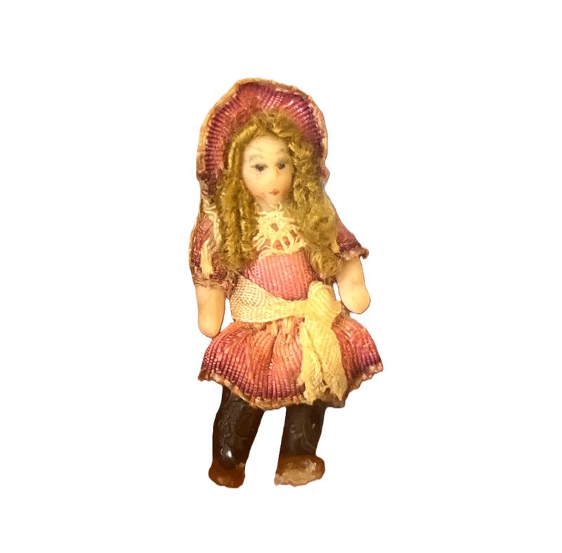 Tiny doll with pink silk dress and bonnet
