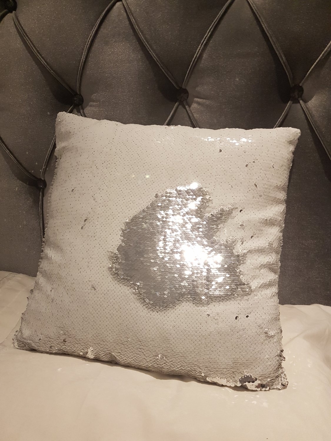 A white & silver sequin cushion