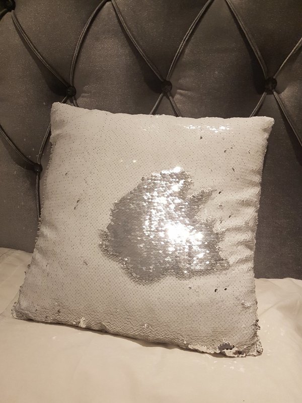 A white & silver sequin cushion