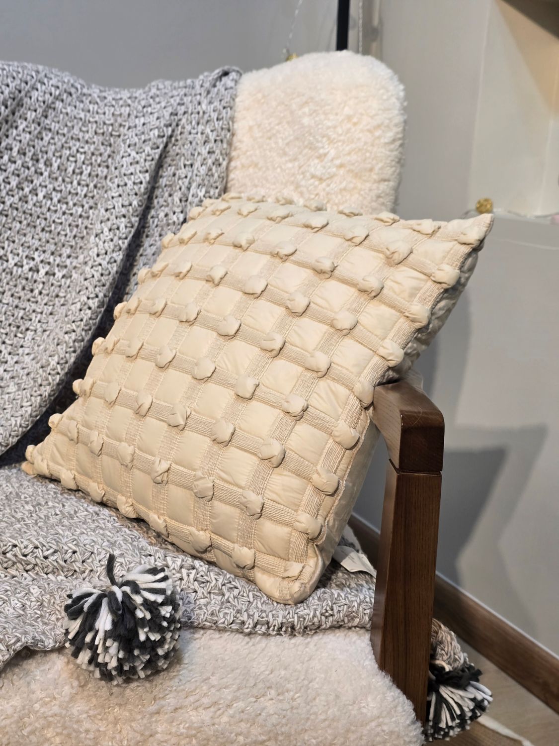White and wood color knitted cushion