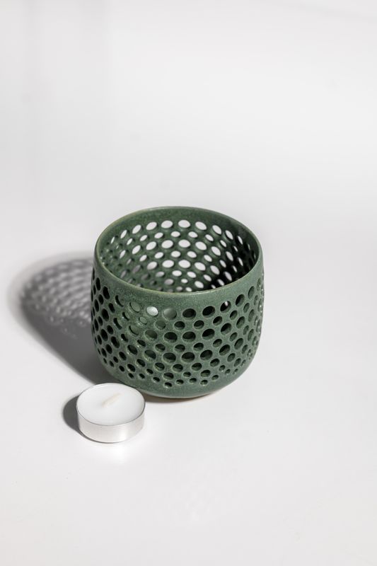 Ceramic tealight candleholder with matte green finish perfect for home decor or accent accessory.