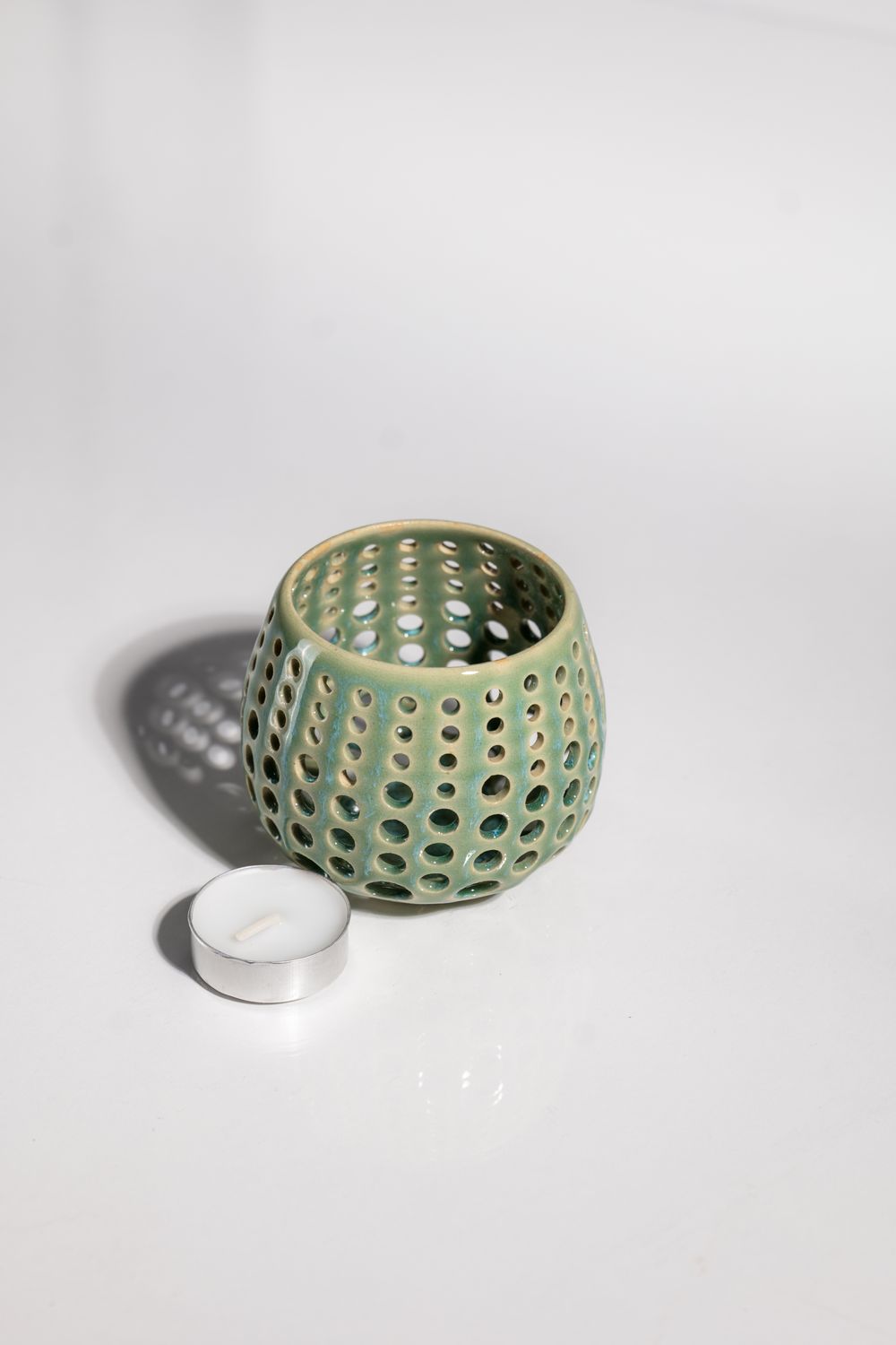 Beachy perforated ceramic votive hurrican candle holder handmade by artisans in the USA in the CORTERRA Clay pottery studio.