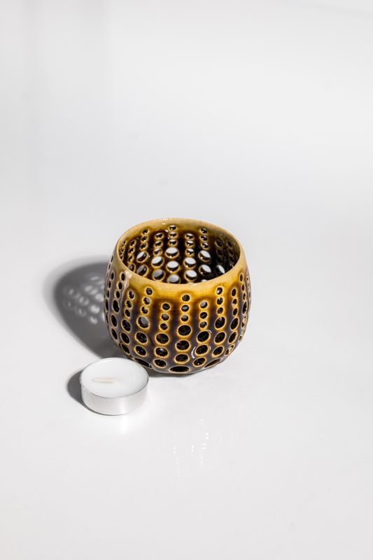 Mid century modern hurricane candleholder with hand punched holes to illuminate light through the vessel by CORTERRA.