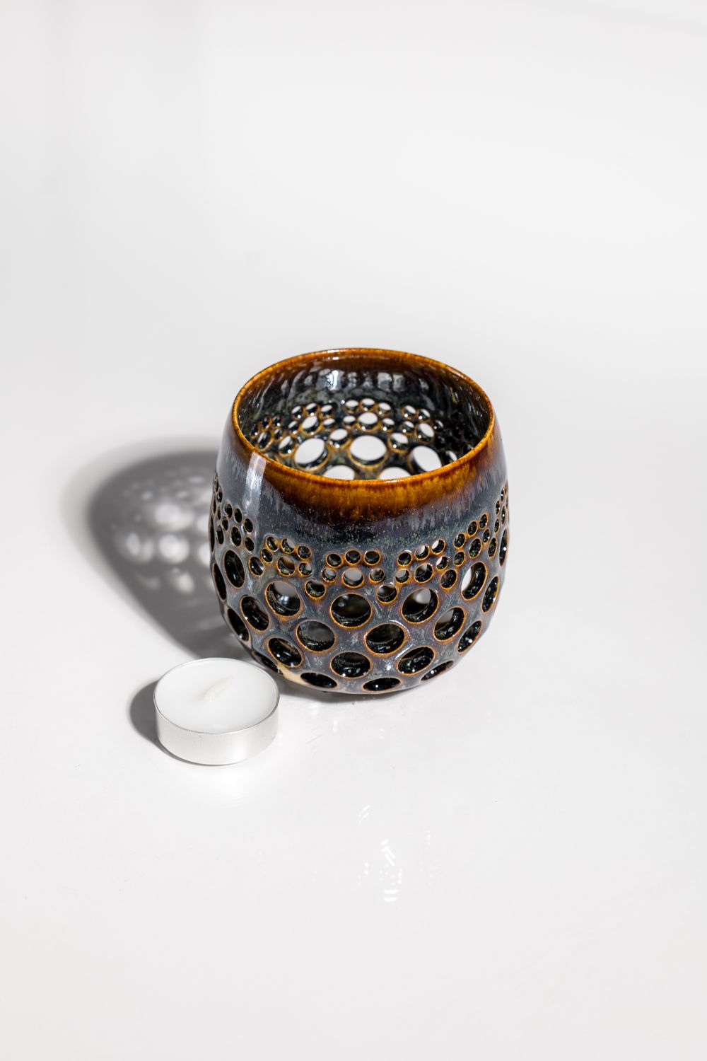 CORTERRA Clay ceramic lantern lumeniere. Rust brown with dark blue overlay glaze and metalic accents. Hand made by CORTERRA