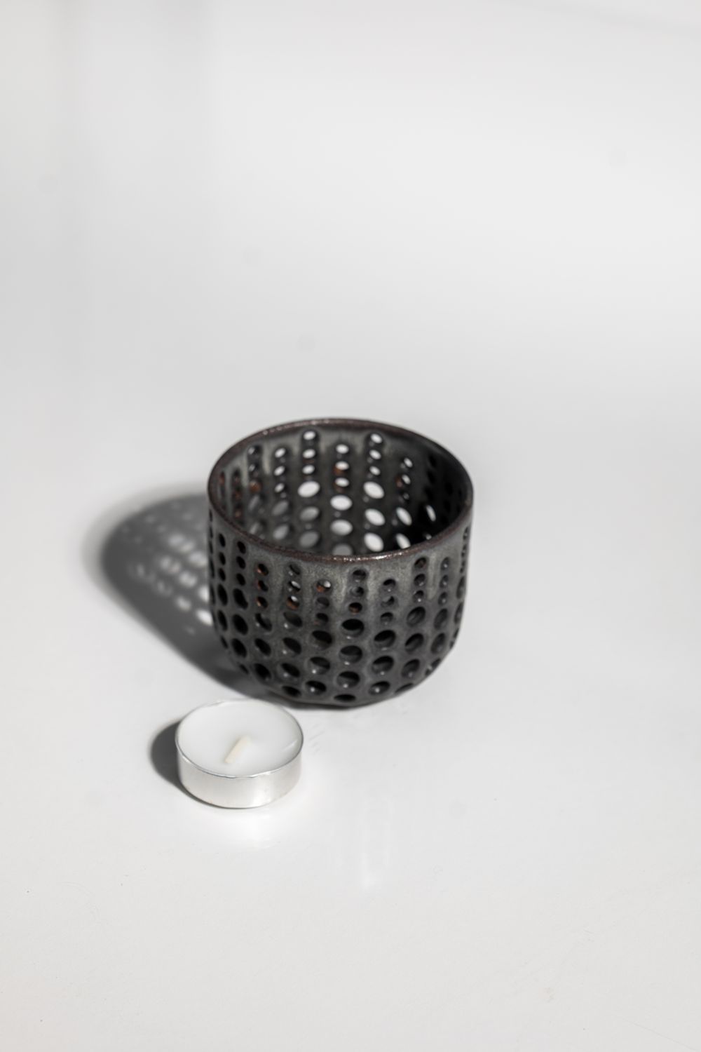 Matte black ceramic candleholder handmade in the USA by local potter at CORTERRA Clay. 