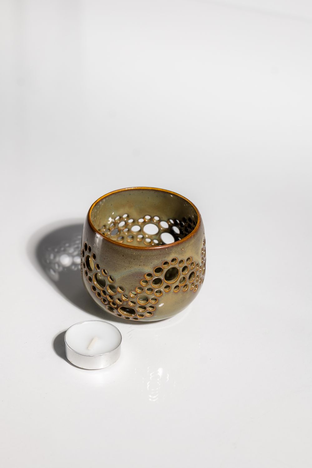 Illuminated ceramic lantern candle holder hand made on the pottery wheel by ceramic artist in USA.