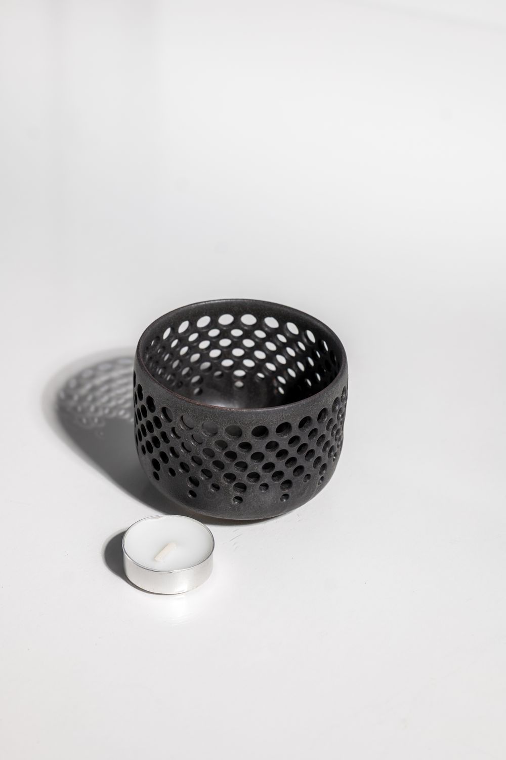 Black minimalist ceramic candleholder for elevating and living space and creating a cozy ambiance. handmade in united states 