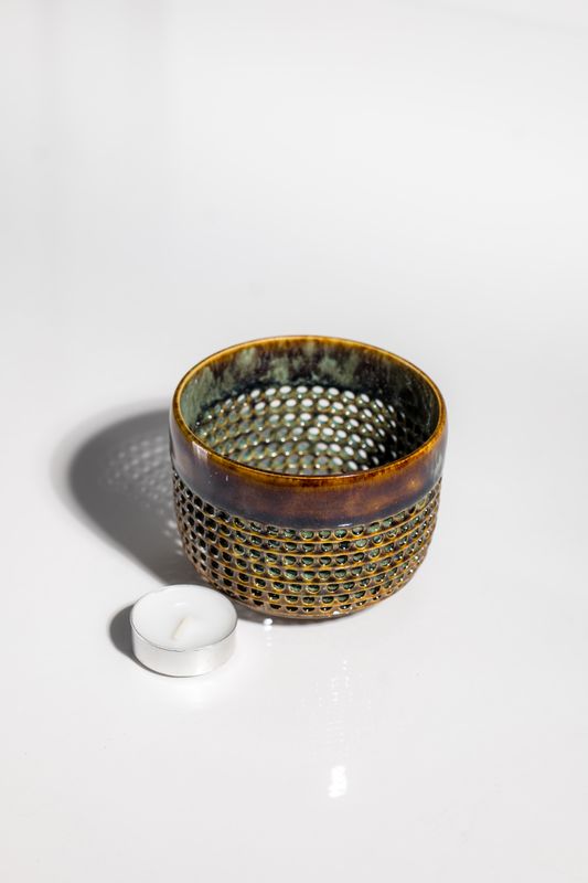 Ceramic tealight candleholder handmade by local artisans in the united sates. Small batch slow made pottery designed for use.