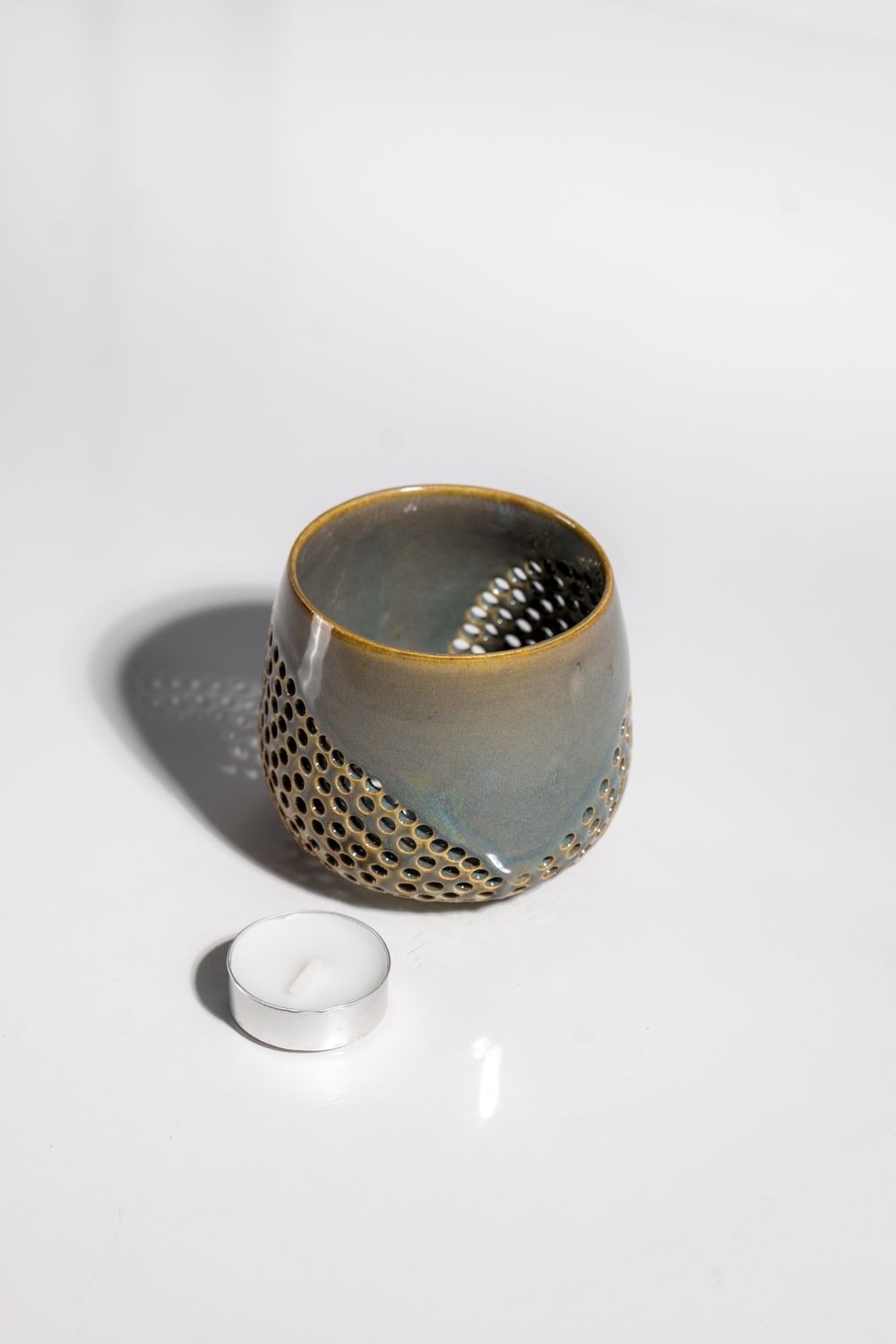 flowing ceramic votive tealight candleholder that was hand made by a local ceramic artist in the USA. Brown and blue glaze 