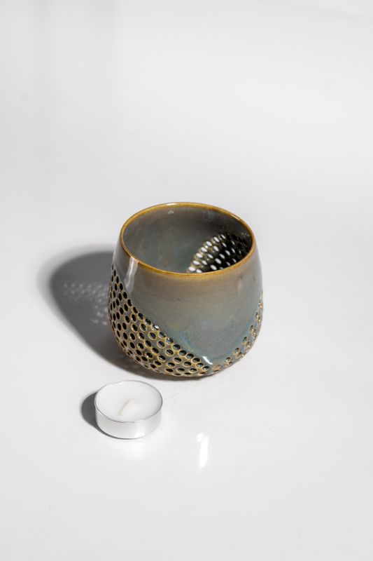 flowing ceramic votive tealight candleholder that was hand made by a local ceramic artist in the USA. Brown and blue glaze 