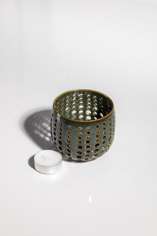 Handmade ceramic tealight candle holder with open perforated structure for atmospheric indoor lighting made by CORTERRA Clay 