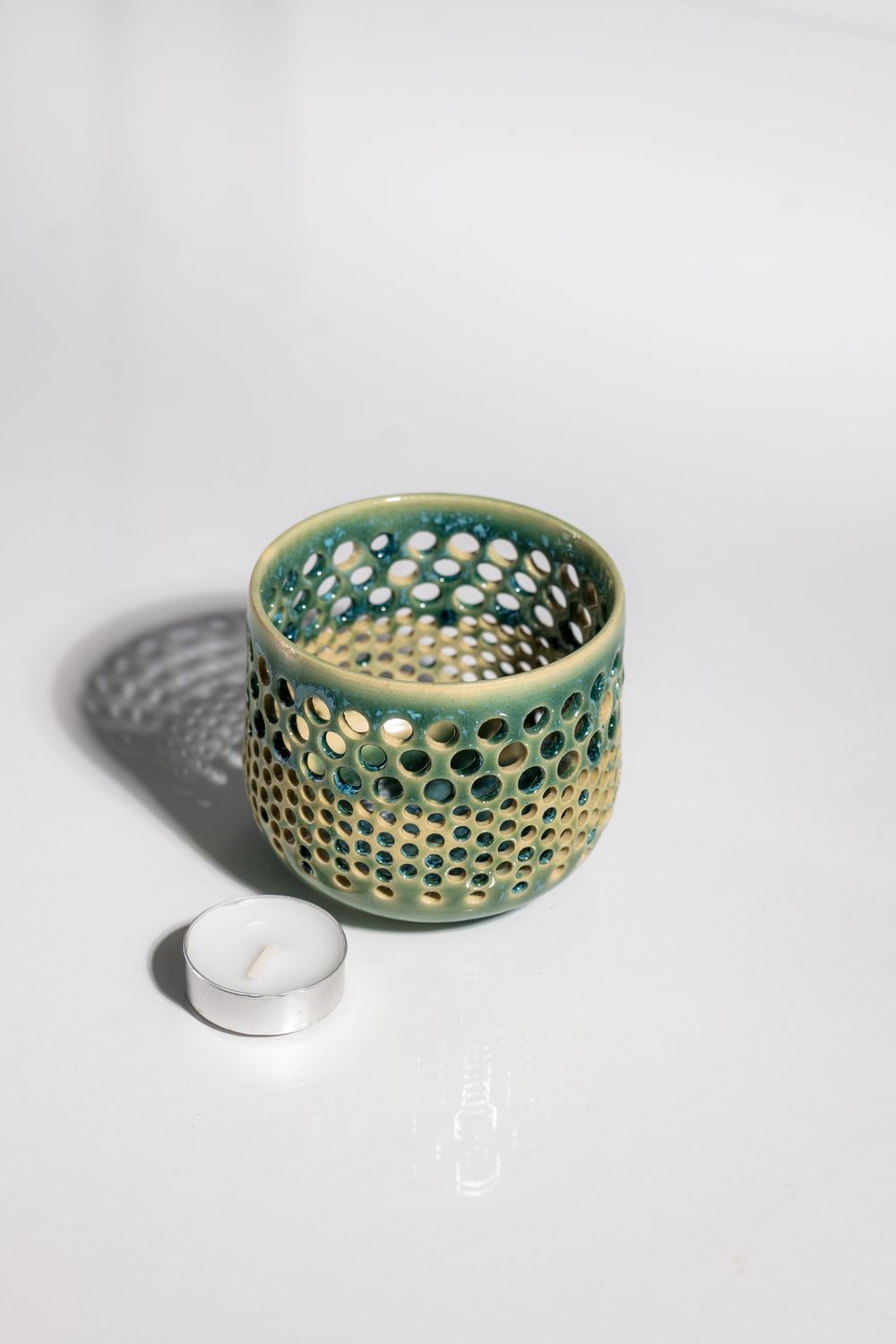 Boho teal and blue ceramic tealight candleholder hand made by small batch pottery studio.