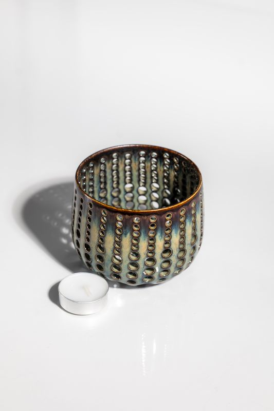 Ceramic tealight candleholder with brown base and dripping blue topcoat glaze. Variable finish from gloss to matte.