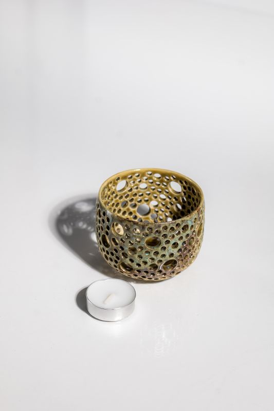 Organic votive ceramic candleholder with pierced holes to illuminate spaces and hold tealight candles. Handmade by artist.