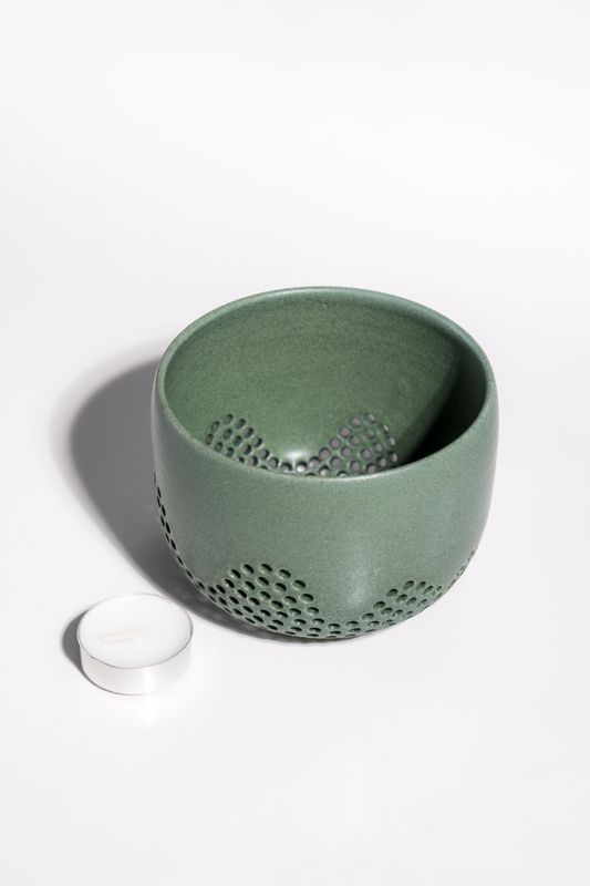 Matte green contemporary ceramic candleholder pierced with small holes. Gifts for mentors and candle lovers. CORTERRA