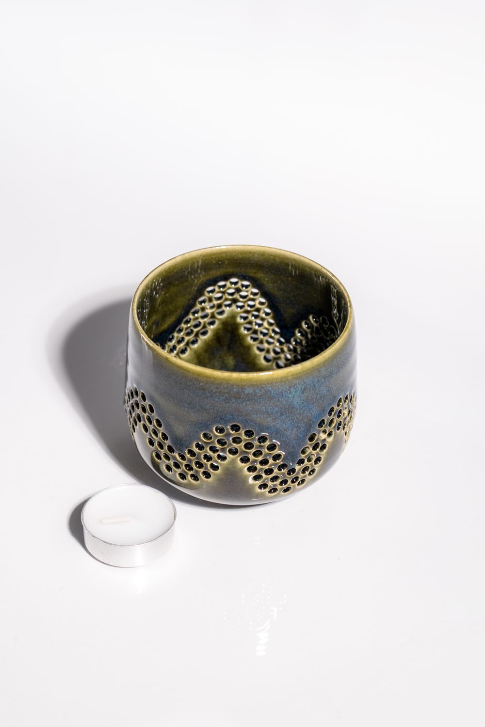 wave like ceramic candleholder with green base and blue accent colors. hand made votive tealight candleholder. 
