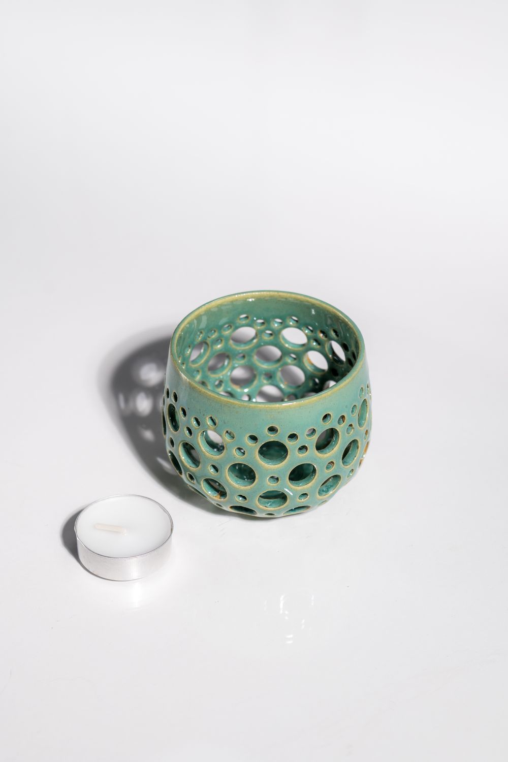Hand made light and airy ceramic tealight or votive candleholder in light blue and green glaze. Lead free glaze and handmade.