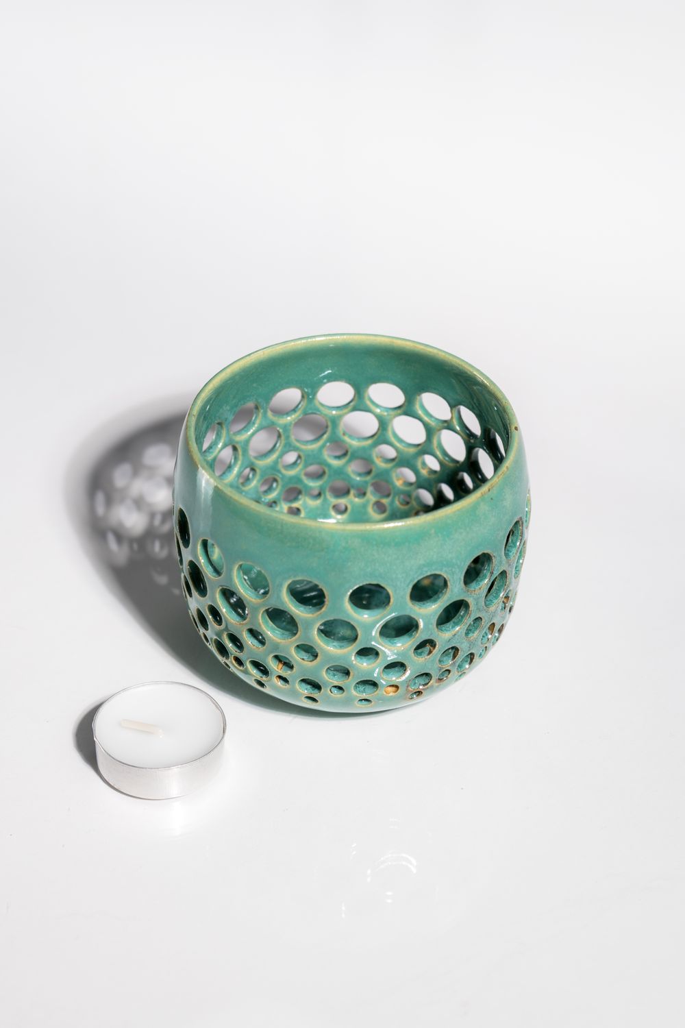 Handmade ceramic art votive candleholder for tealights. Blue green and hand made on the wheel. One of a kind