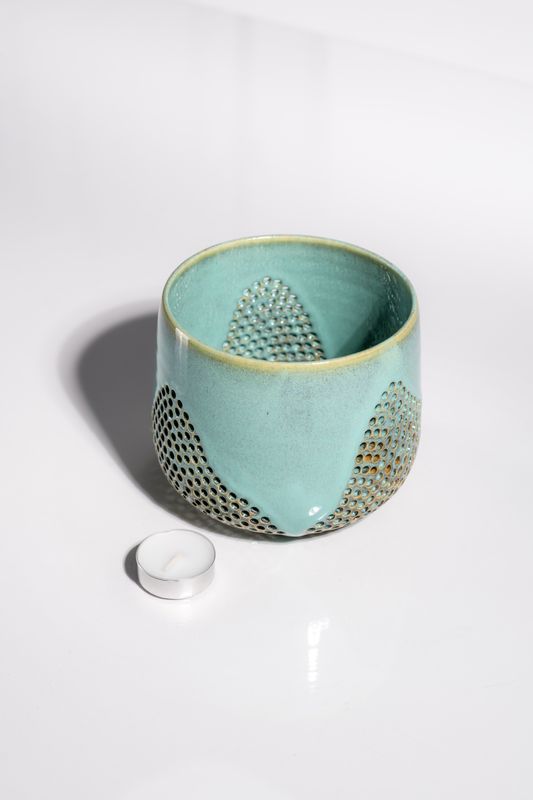 Light carribean blue candleholder reminiscent of the ocean with a wave like pattern that is perfect decor for beach cottage