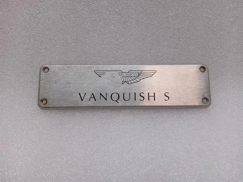 ASTON MARTIN VANQUISH S 04-07 V12 COVER VANQUISH S DOOR POST LOGO PLATE