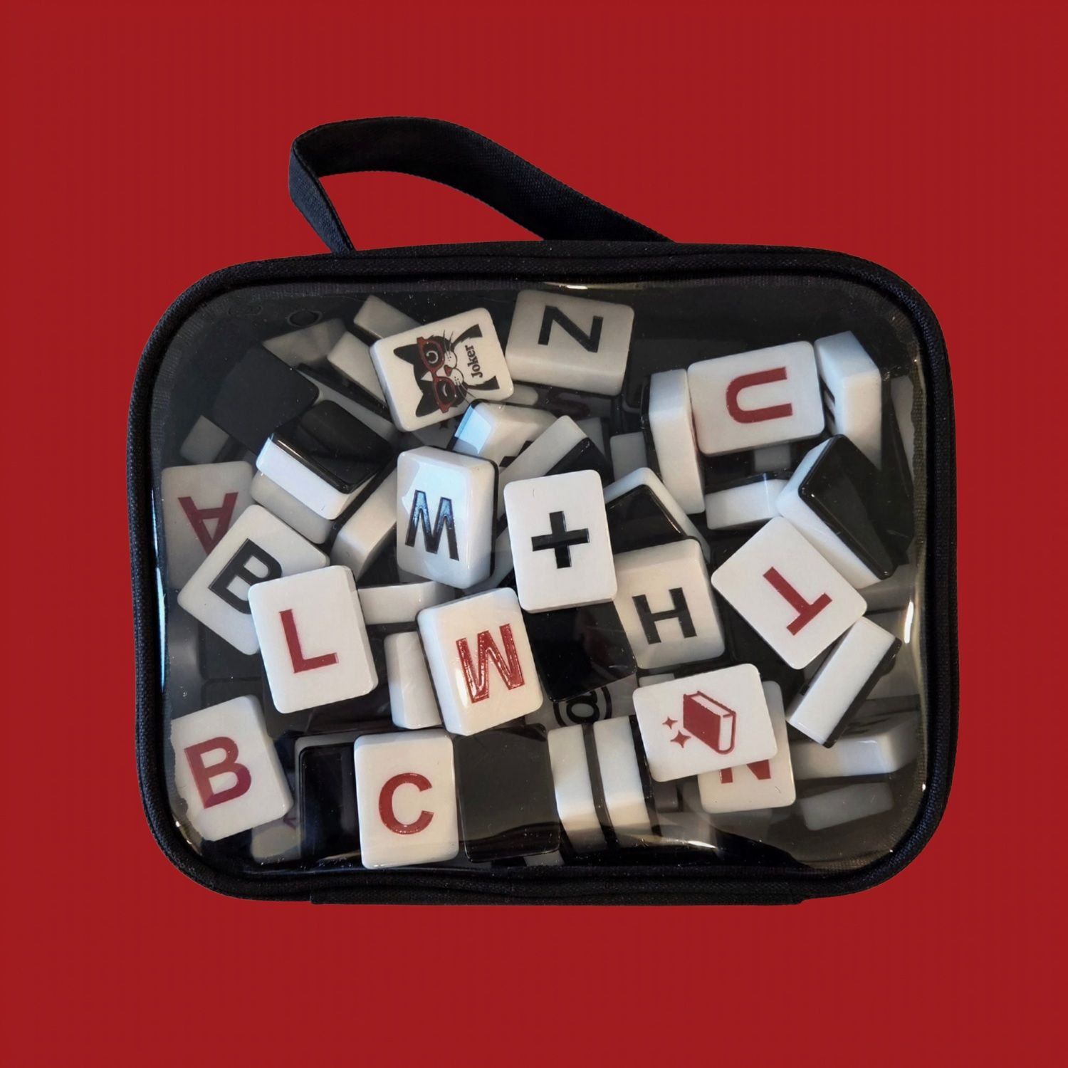 Deep Red noQ engraved letter tiles close-up on red background