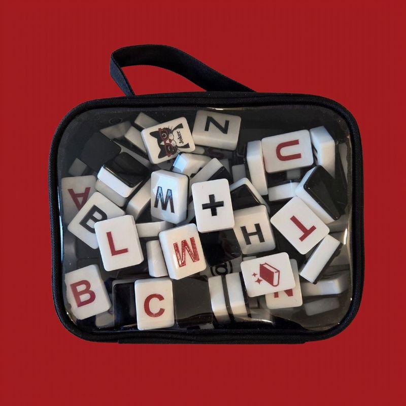 Deep Red noQ engraved letter tiles close-up on red background