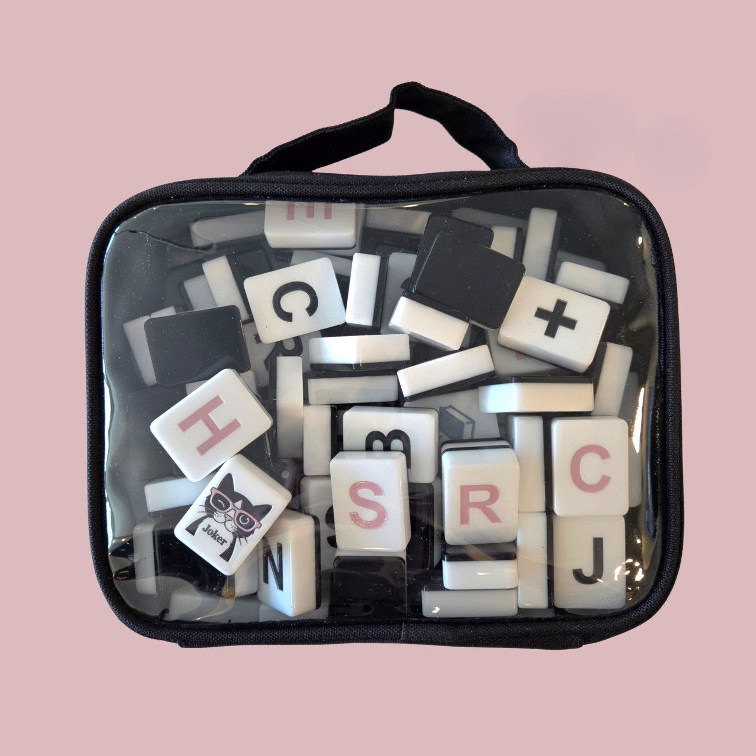Dusty Pink noQ engraved letter tiles close-up on pink background