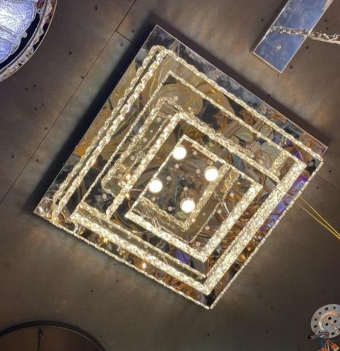Large square ceiling lamp, Let Lampa, with modern crystal/glass design, sparkling details, and bright lighting, featuring concentric square shape and five central bulbs.