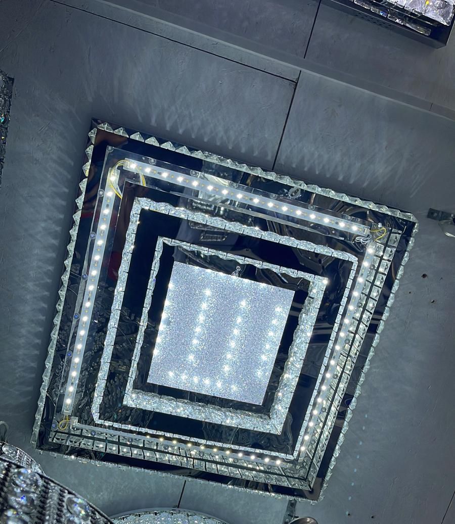 Large crystal ceiling lamp, modern design with sparkling glass details, square shape, multiple layers, bright white lights, elegant and luxurious lighting fixture.