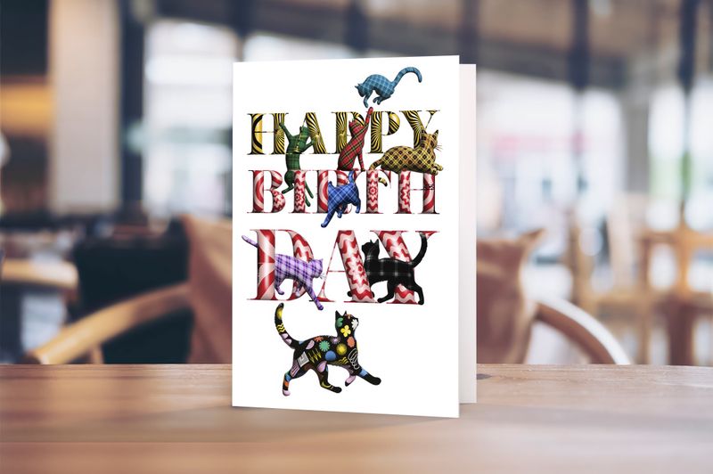 5 x 7" portrait greetings card featuring illustrated tartan cats in a playful birthday design.