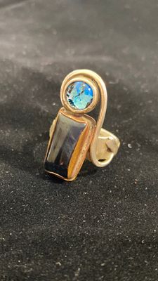 Black tiger’s eye and blue dichroic glass with copper and Freeform silver bezel