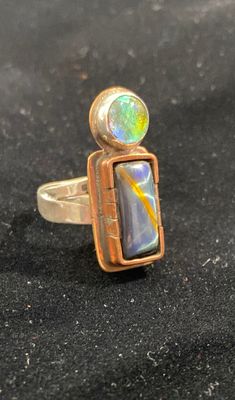 Black tiger’s eye and green dichroic glass with copper and brass bezel