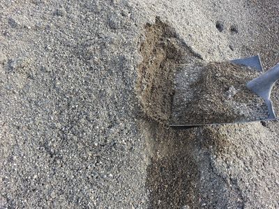 Shovel lifting washed concrete sand from a bulk pile at the Soracco supply yard in Yakima.