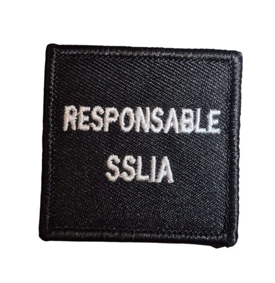 Grade / galon RESPONSABLE SSLIA / Pompiers d’aéroport - broderie blanc sur tissu noir avec support auto-agrippant BG-SAFETY