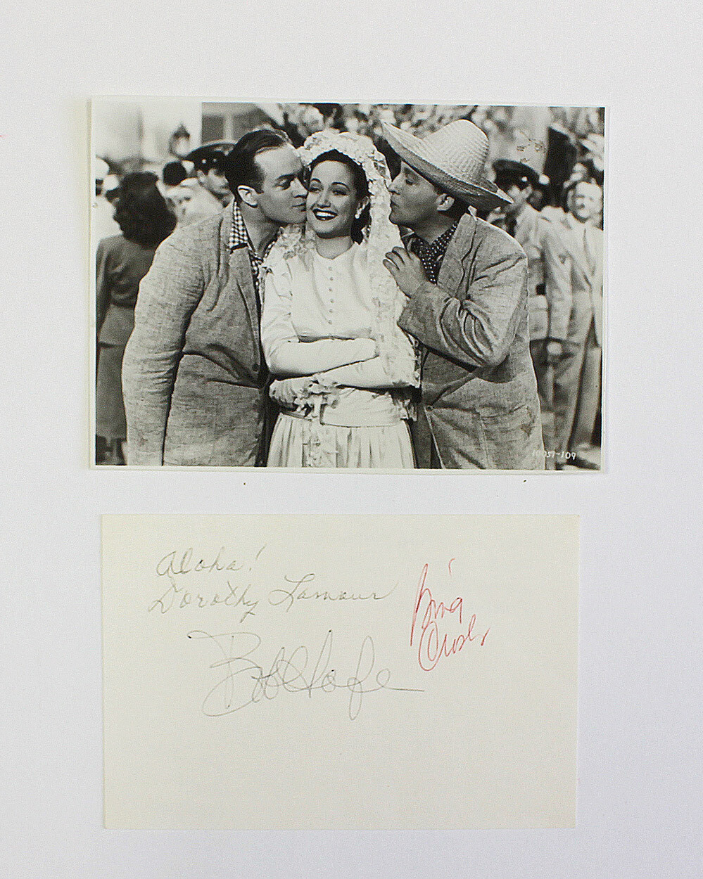 An Original Photograph and Signed Card by Bing Crosby, Bob Hope, and Dorothy Lamour. All three starts appeared in the Road to Series of seven comedy films