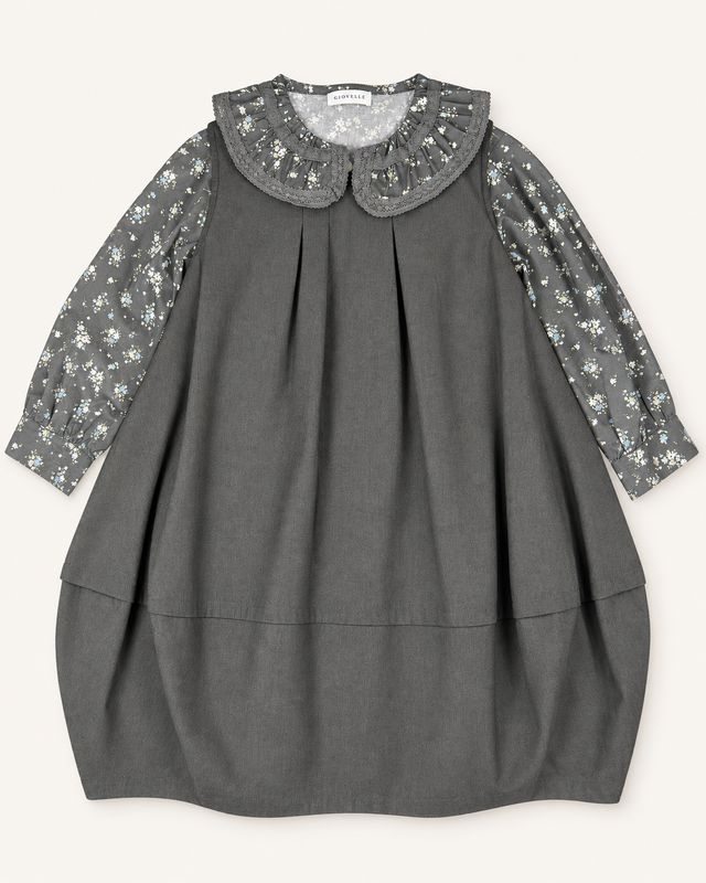 Charcoal-brown pinafore ensemble front view with floral sleeves and lace-edged ruffle collar.