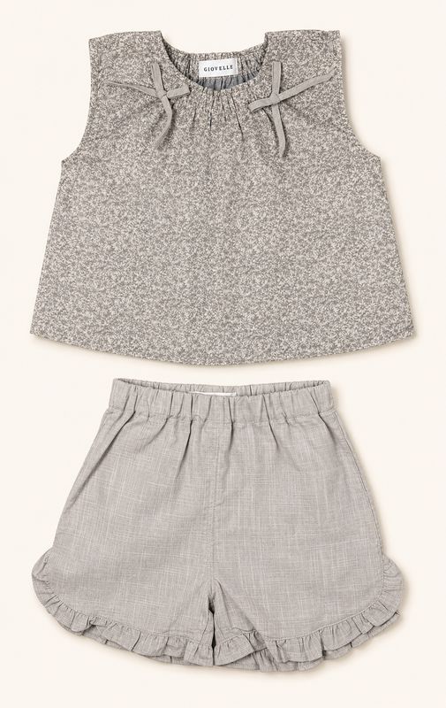 Warm taupe floral sleeveless top and soft stone ruffle shorts front view.