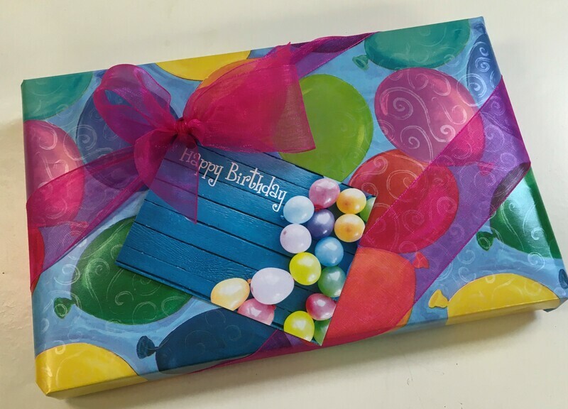 Happy Birthday Chocolate Assortments wrapped with bow.