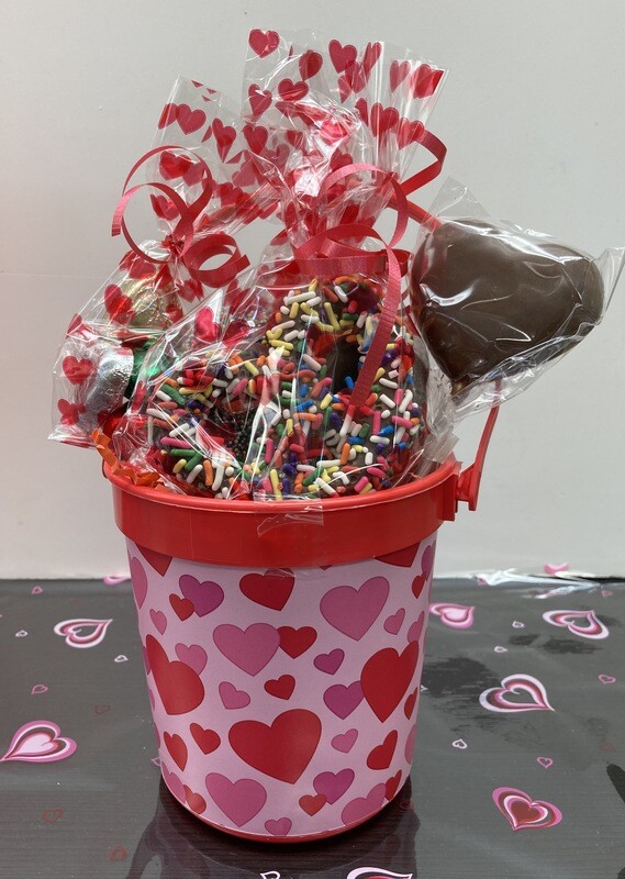 Bucket of Love!  Includes 3-3Ring Gourmet Pretzels, One milk chocolate heart pop, foiled solid milk hearts and some gummy bears. 
Great for kids or Adults!