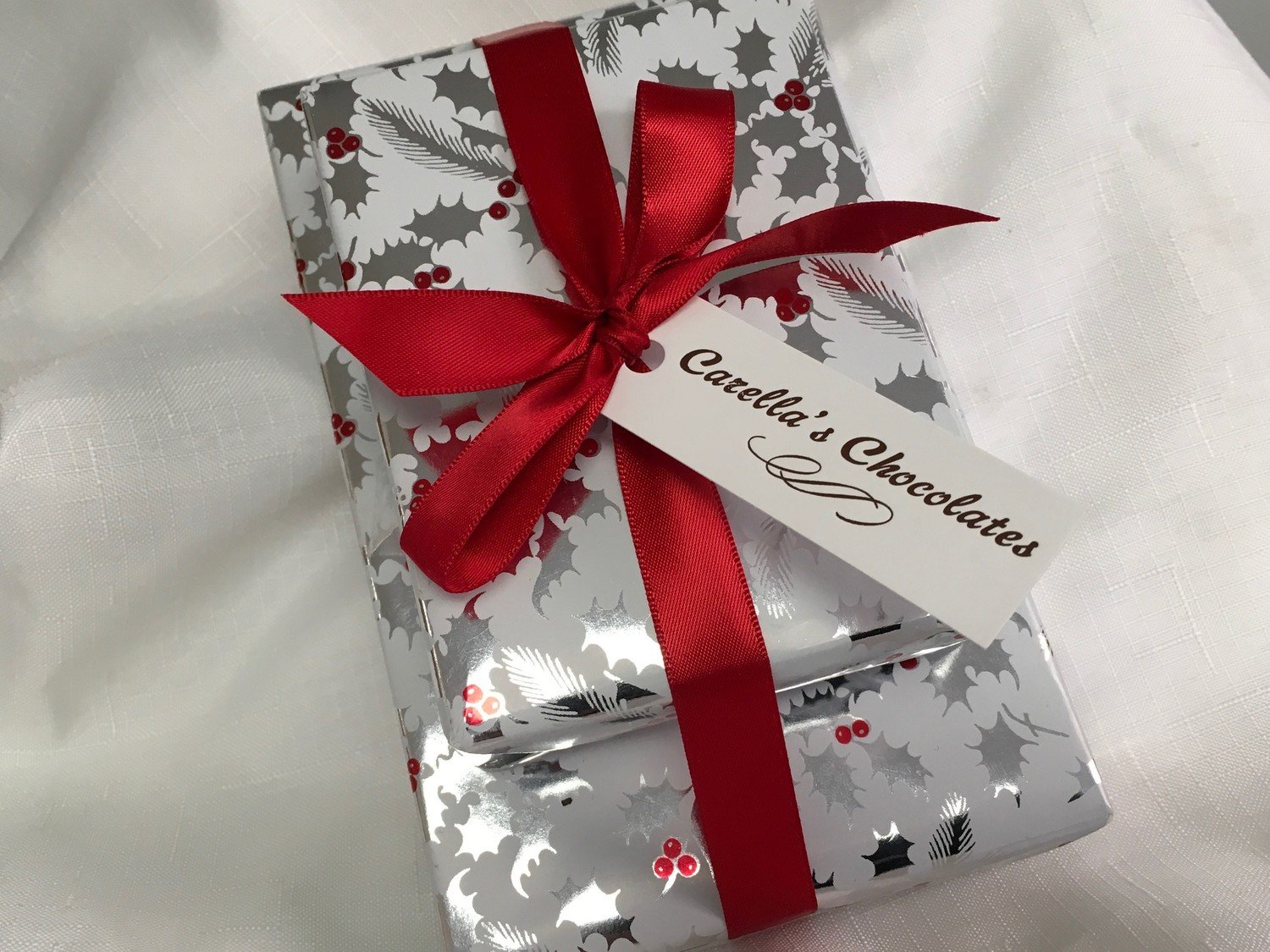 Three Tier Asst. Chocolates. 1 Lb. Assorted Chocolates, 1/2 Lb. Assorted 3 Ring Gourmet Pretzels and 1/2 Lb. Assorted Mini Pretzels. Wrapped w/Bow.