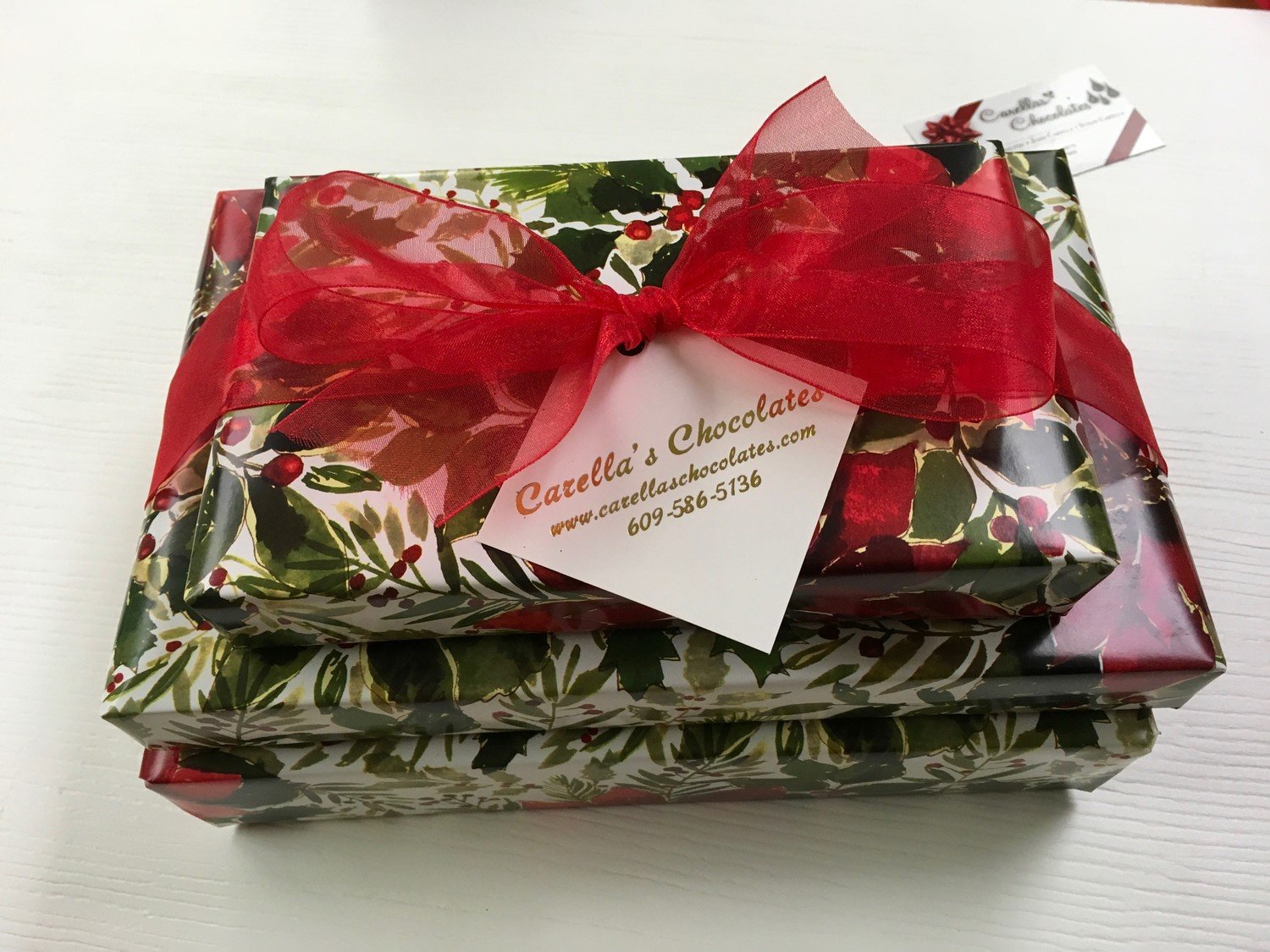 3 Tiered Holiday Chocolate Assortment. 2Lb. box Assorted chocolates wrapped and bowed, 1 Lb. box Assorted Truffles, 1/3 Lb. Mini Pretzels Assorted Mk &amp; Dk