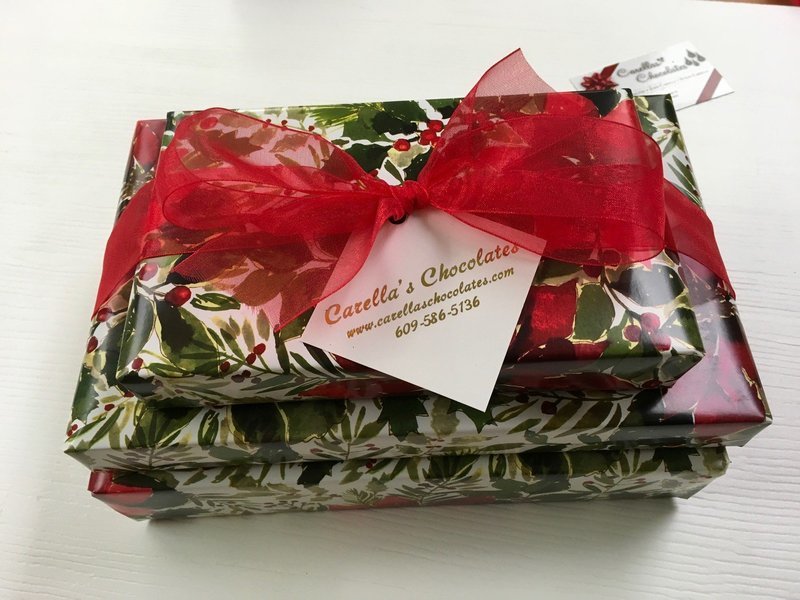 3 Tiered Holiday Chocolate Assortment. 2Lb. box Assorted chocolates wrapped and bowed, 1 Lb. box Assorted Truffles, 1/3 Lb. Mini Pretzels Assorted Mk & Dk 3 Tiered Holiday Chocolate Assortment. 2Lb. box Assorted chocolates wrapped and bowed, 1 Lb. box Assorted Truffles, 1/3 Lb. Mini Pretzels Assorted Mk & Dk