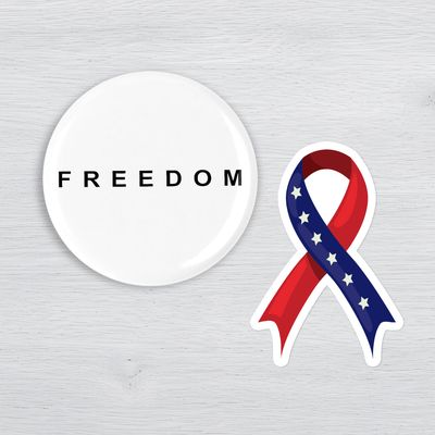 Patriotic freedom button and American flag ribbon sticker with USA pride themed accessories.