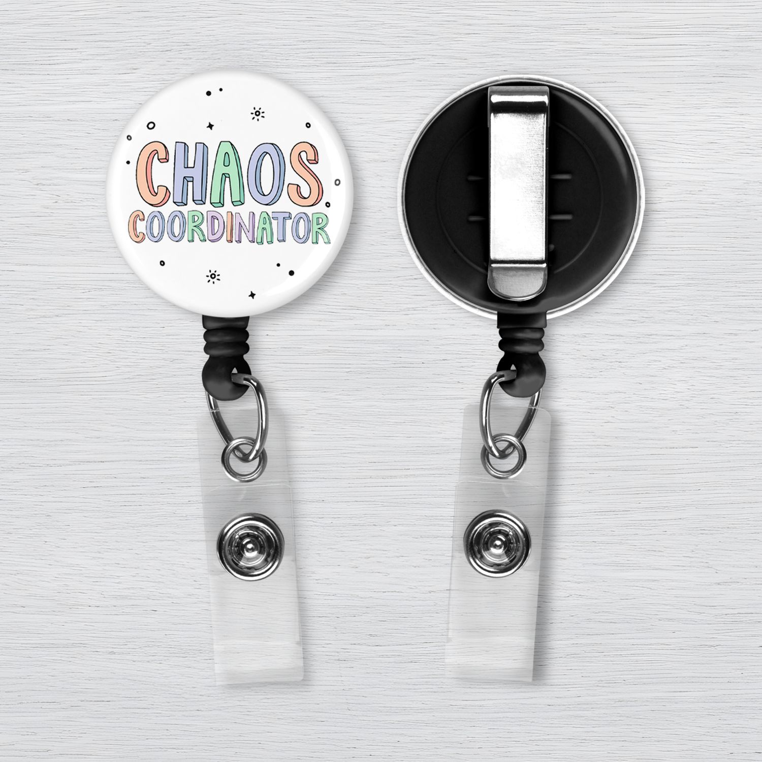 Chaos Coordinator Badge Reel | Nurse Gift White retractable badge reel with pastel “Chaos Coordinator” lettering and black accent dots displayed from the front & back.
