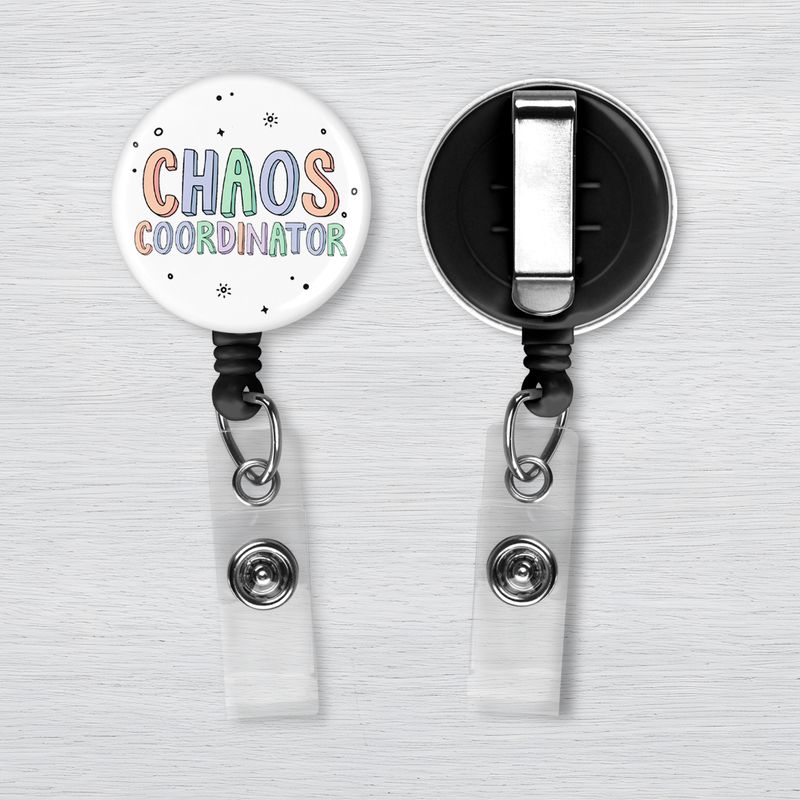 Chaos Coordinator Badge Reel | Nurse Gift White retractable badge reel with pastel “Chaos Coordinator” lettering and black accent dots displayed from the front & back.