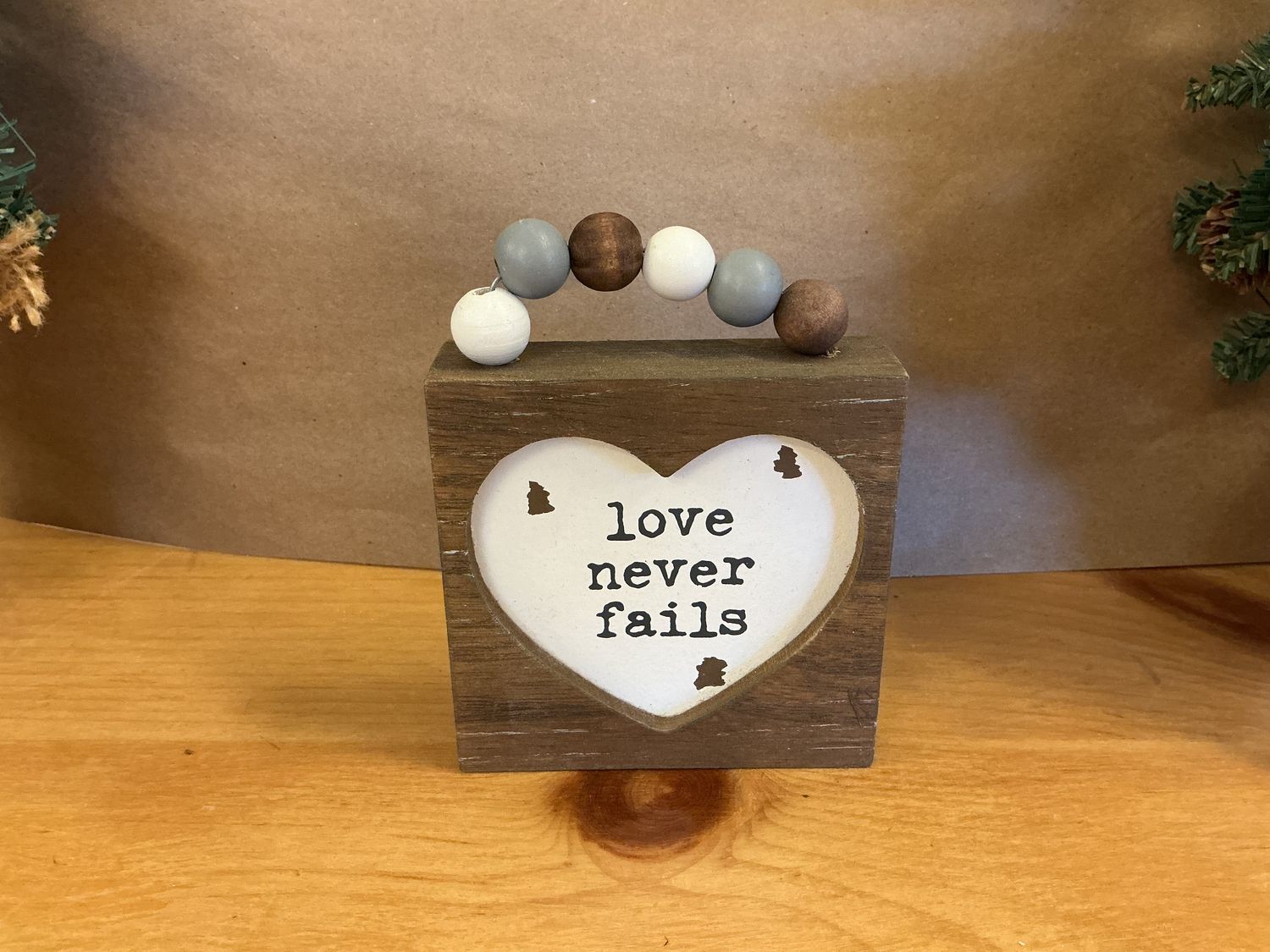Love Never Fails - Wooden Sign w/ Beads