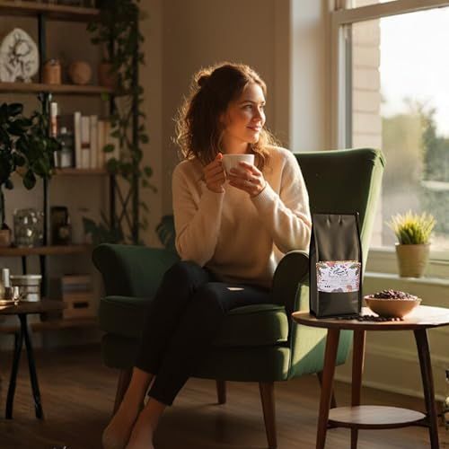 First Bean Medium Roast House Blend 1kg coffee bag on a table next to a woman holding a cup, 100% A…